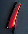 Anime-inspired LED katana with glowing red blade and matching sheath on a flat surface