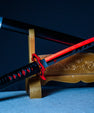 Anime-inspired red and black katana sword on decorative wooden stand