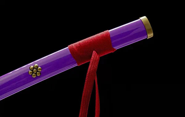 Purple katana scabbard with gold cap, red cord wrap, and floral emblem, on black background.